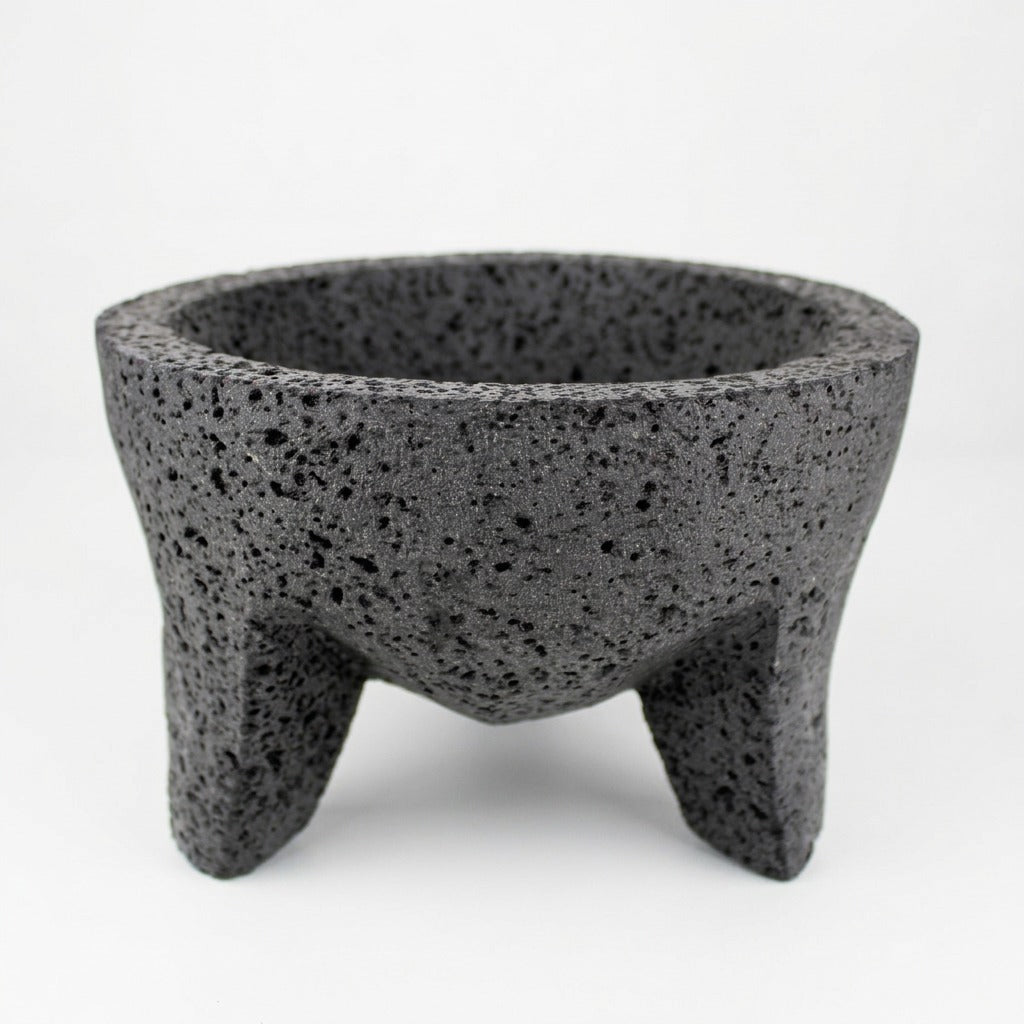 Close view of a volcanic stone molcajete showing the natural pores of real lava rock