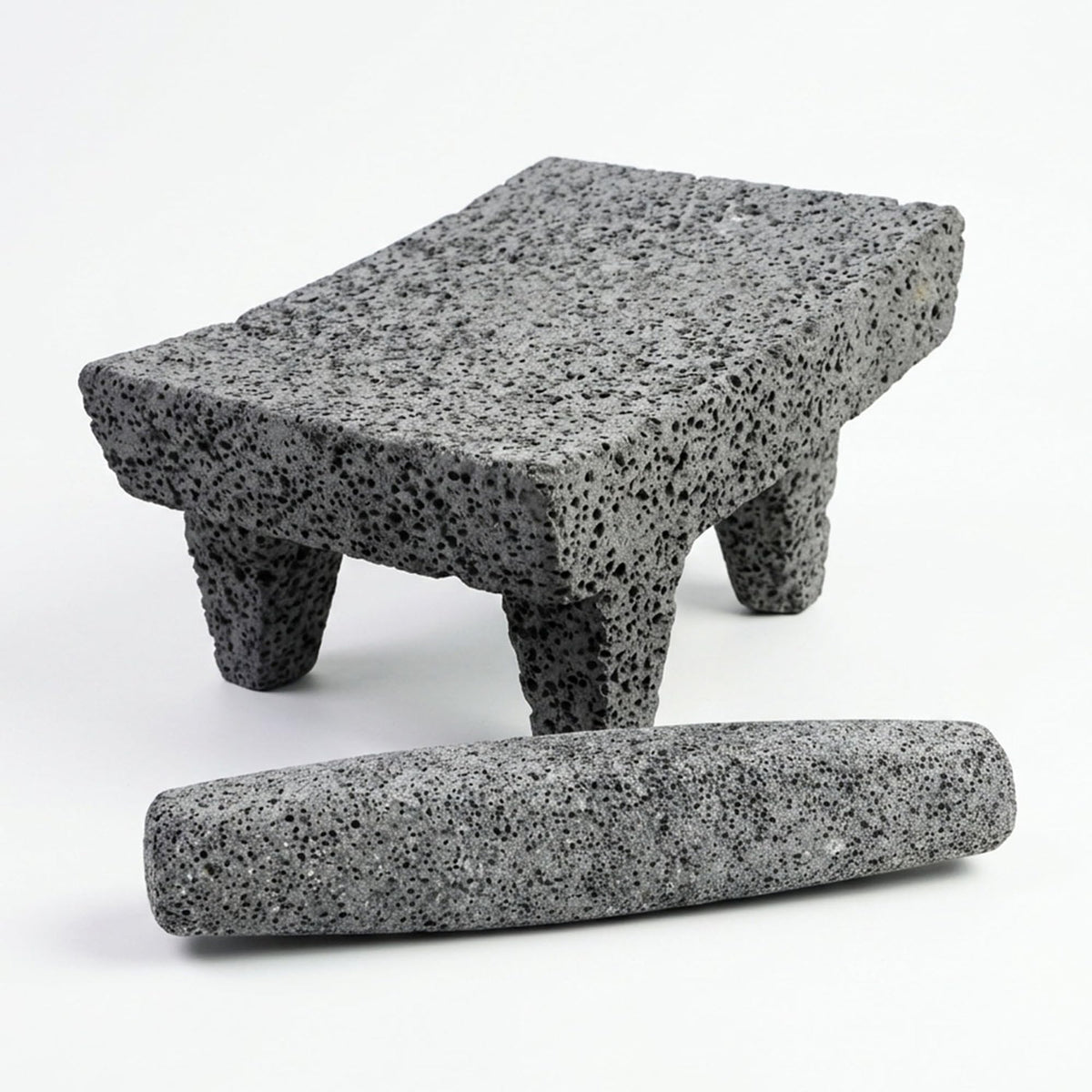 Mexican metate of volcanic rock with its mano roller stone