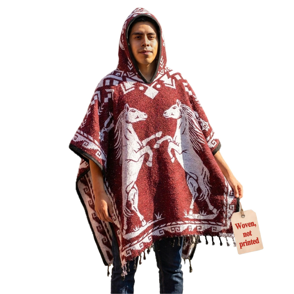 Model wearing the Red Horse hooded Mexican poncho in burgundy, front view on white