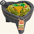 Heart molcajete with 3 legs made of volcanic rock, filled with guacamole