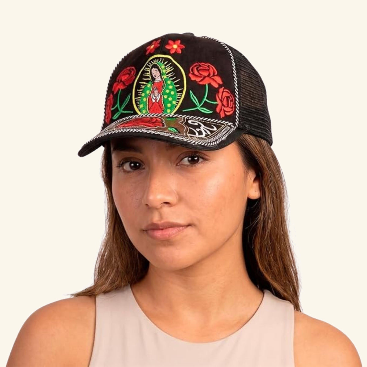 Woman wearing the Our Lady of Guadalupe embroidered cap with red roses