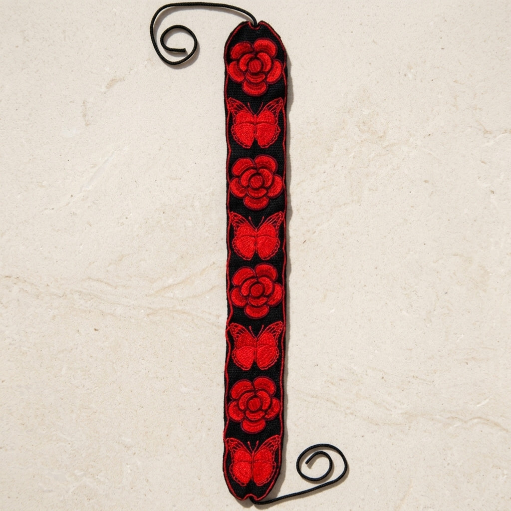 Red floral embroidered Mexican belt with roses and butterflies shown full length with tie cords