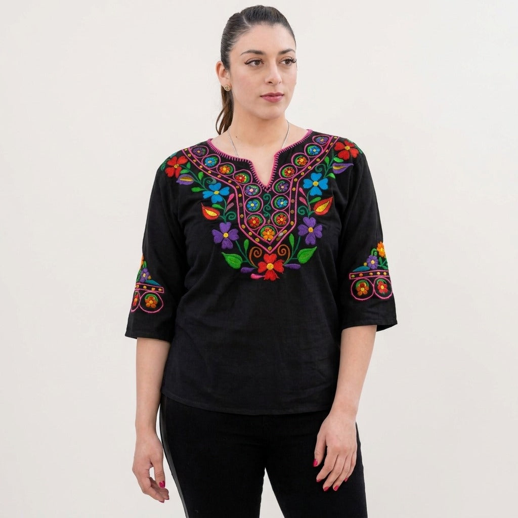 Black embroidered Mexican blouse with pink neckline and floral embroidery, front view